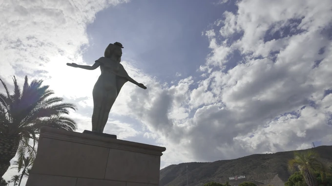 Statue Against Cloudy Sky
