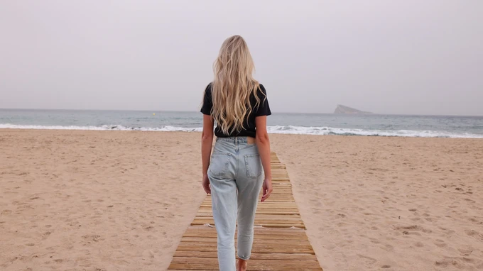 Woman Walking on Beach Boardwalk