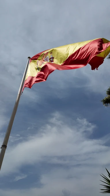 Spanish Flag Against Blue Sky