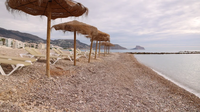 Sunny Beach with Straw Umbrellas